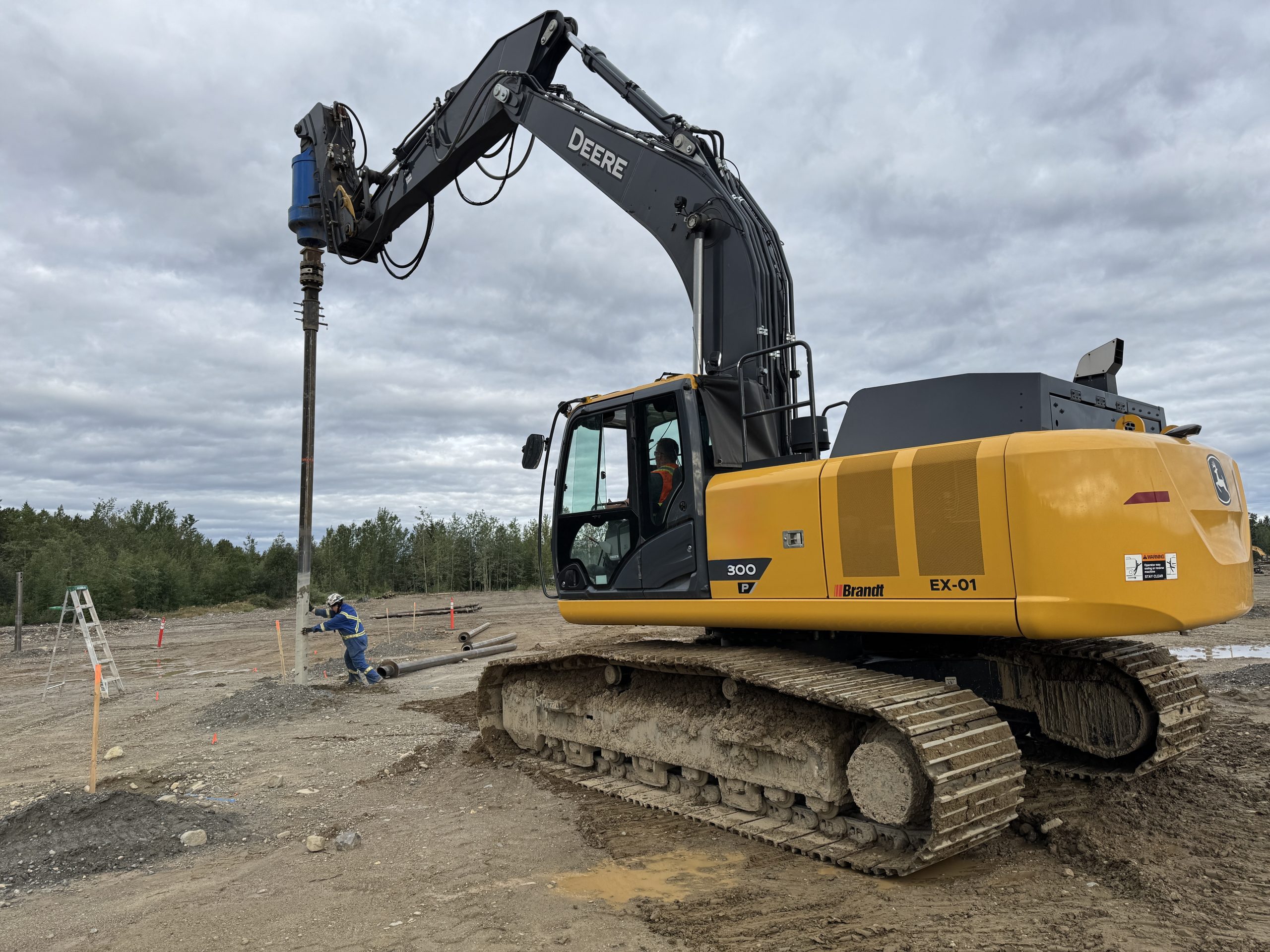 helical pile driver installing screw piles for a foundation